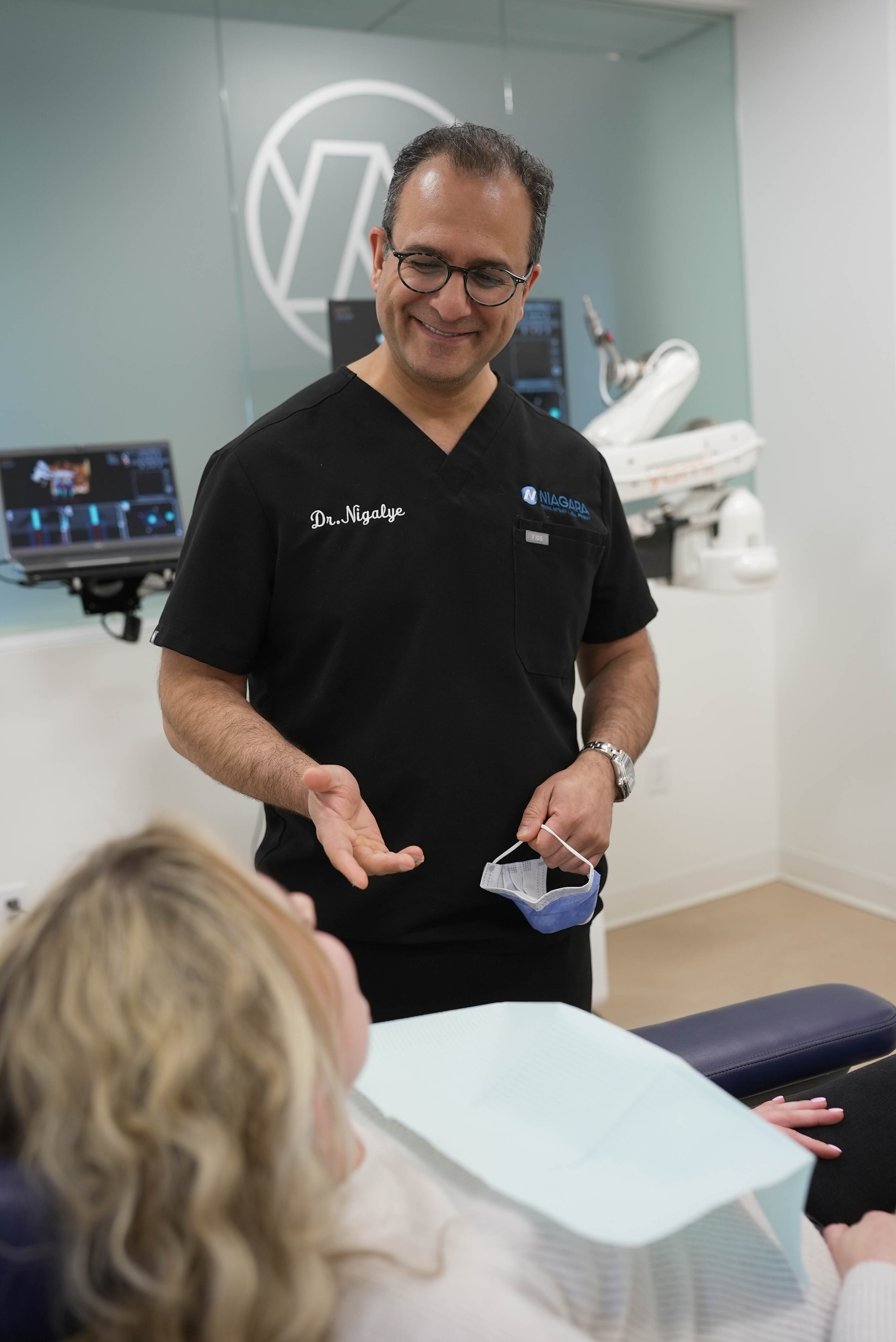 Dr. Nigalye reviewing treatment with a patient